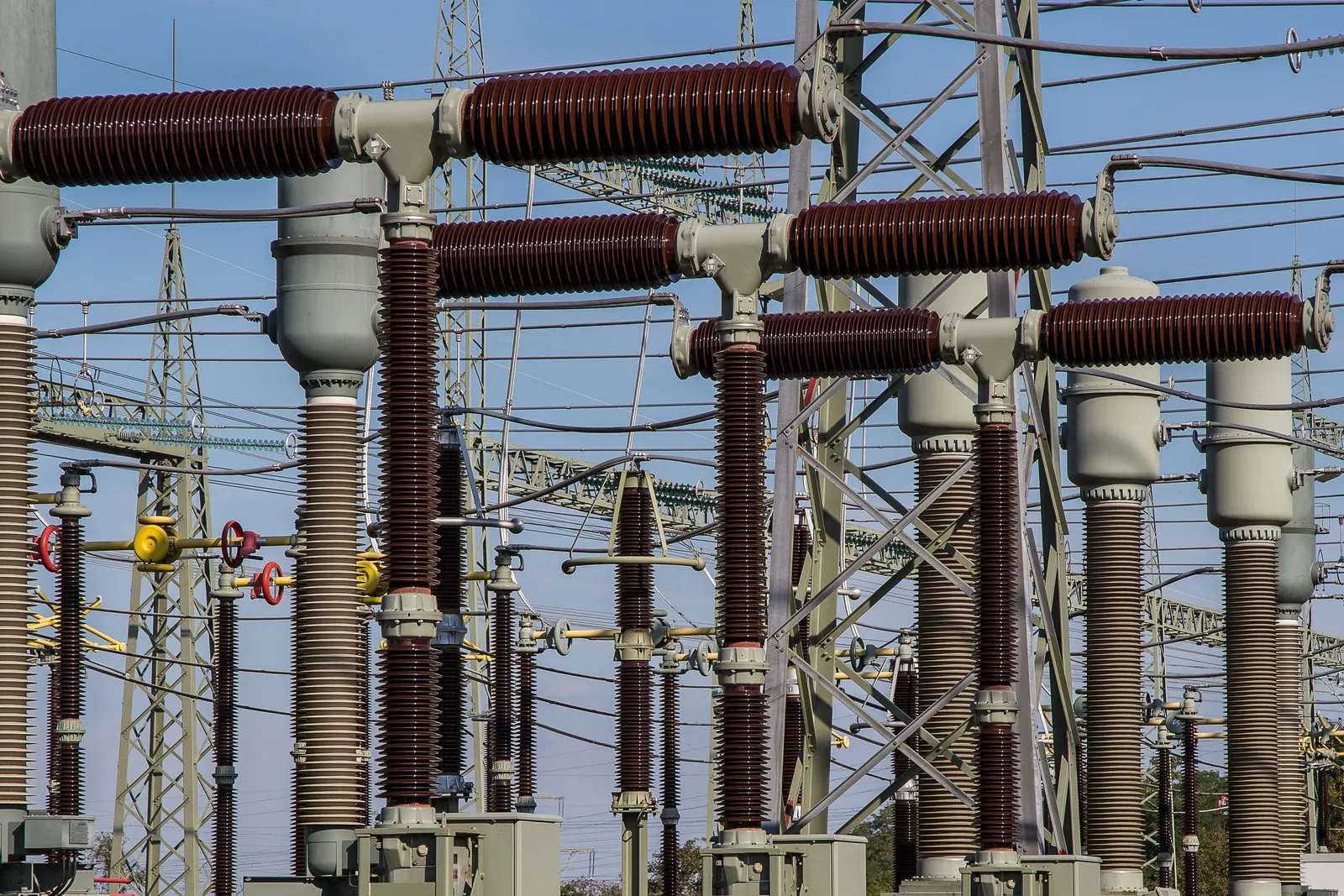 High-voltage insulators and switchgear in an electrical substation
